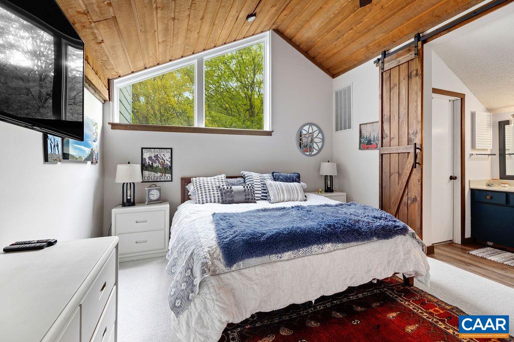 1403 Highlands Roseland, VA 22967 - Photo 24 of 29 a bedroom with a bed and a flat tv screen on dresser