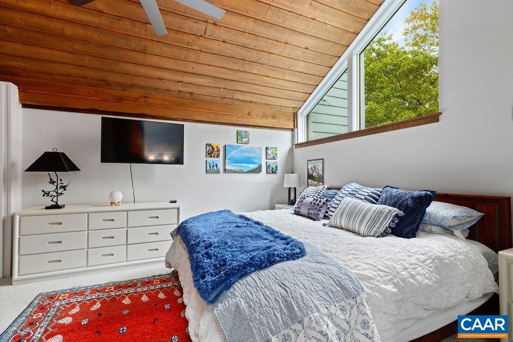 1403 Highlands Roseland, VA 22967 - Photo 25 of 29 a bedroom with a large bed and a flat tv screen on dresser