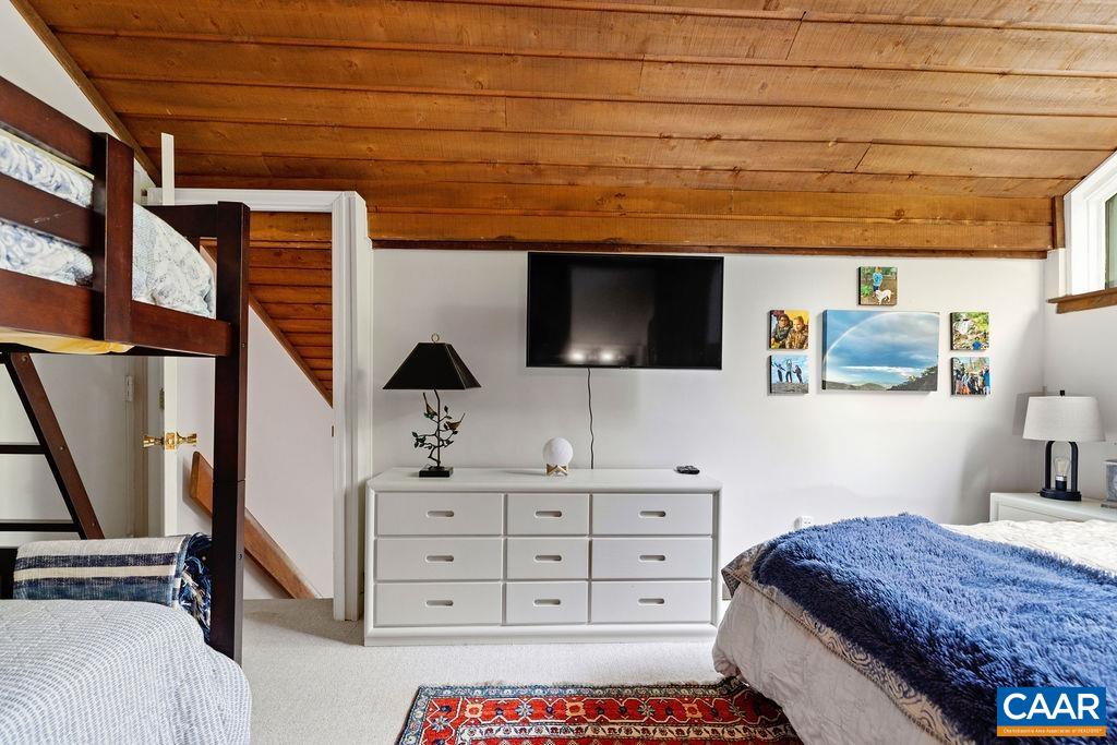 1403 Highlands Roseland, VA 22967 - Photo 27 of 29 a bedroom with a bed a dresser and flat screen tv