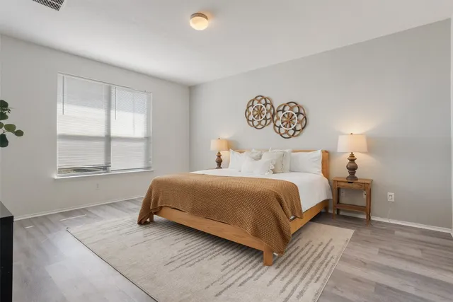 a bedroom with a bed and window