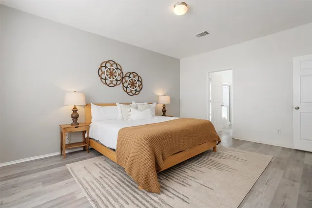 a bedroom with a bed and a table