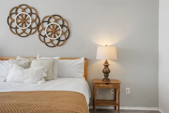 a bedroom with a bed and lamp