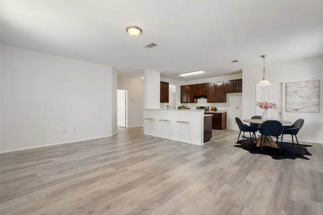 a view of a kitchen with kitchen island a sink stainless steel appliances and cabinets
