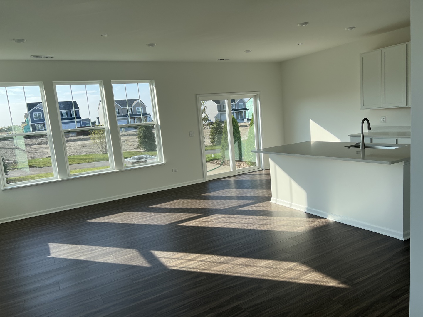 146 Henderson Street Oswego, IL 60543 - Photo 5 of 19 a view of an empty room with wooden floor and a window