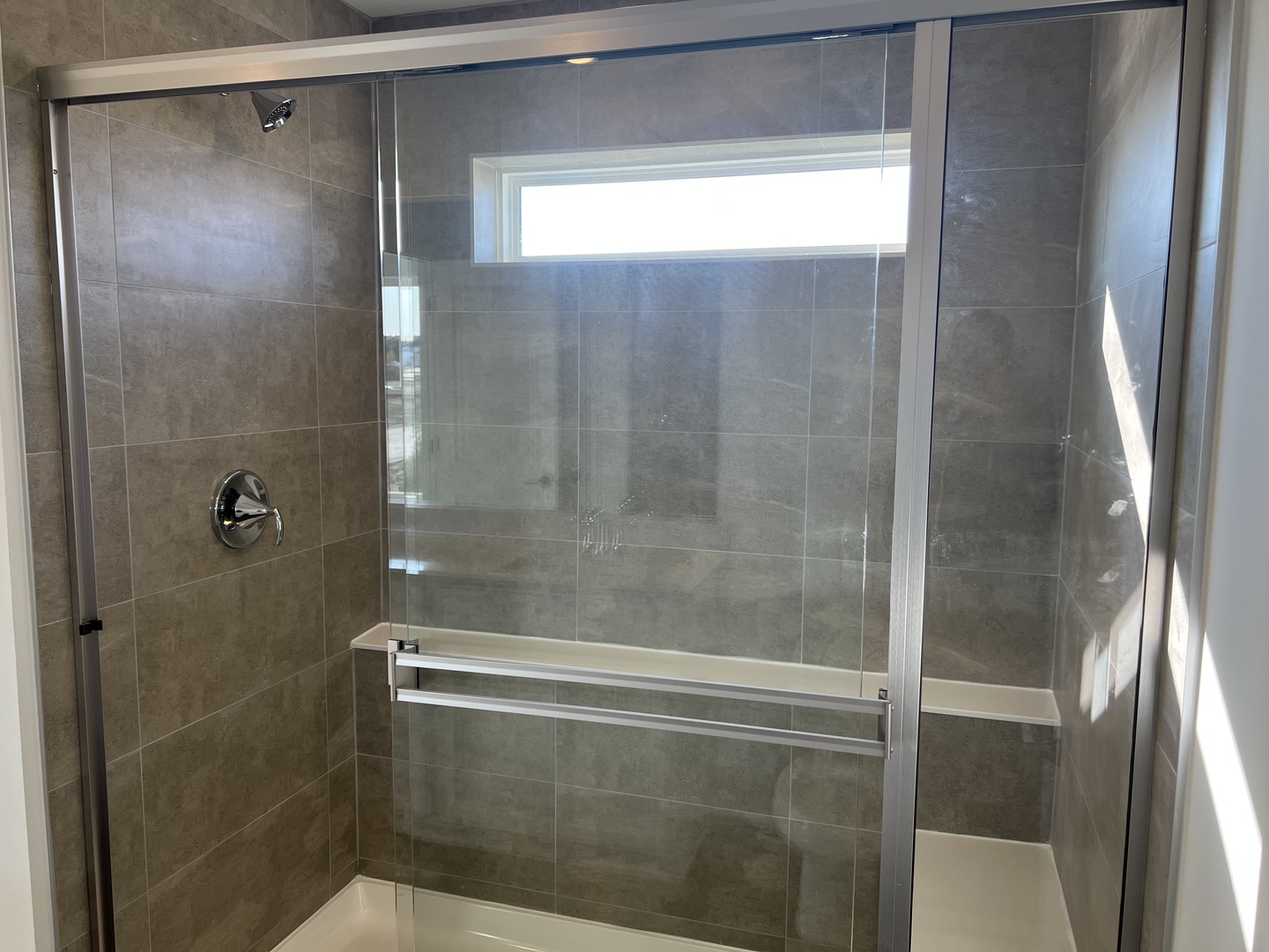 146 Henderson Street Oswego, IL 60543 - Photo 10 of 19 a bathroom with a glass shower door