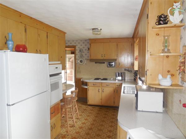 117 Dewitt Street Springfield, MA 01129 - Photo 3 of 14 a kitchen with stainless steel appliances a refrigerator sink and white cabinets