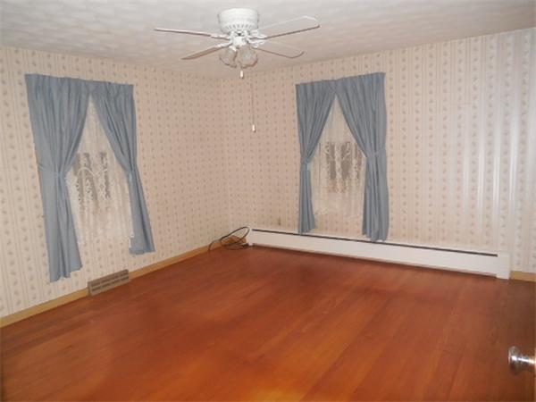 117 Dewitt Street Springfield, MA 01129 - Photo 6 of 14 an empty room with windows and fan