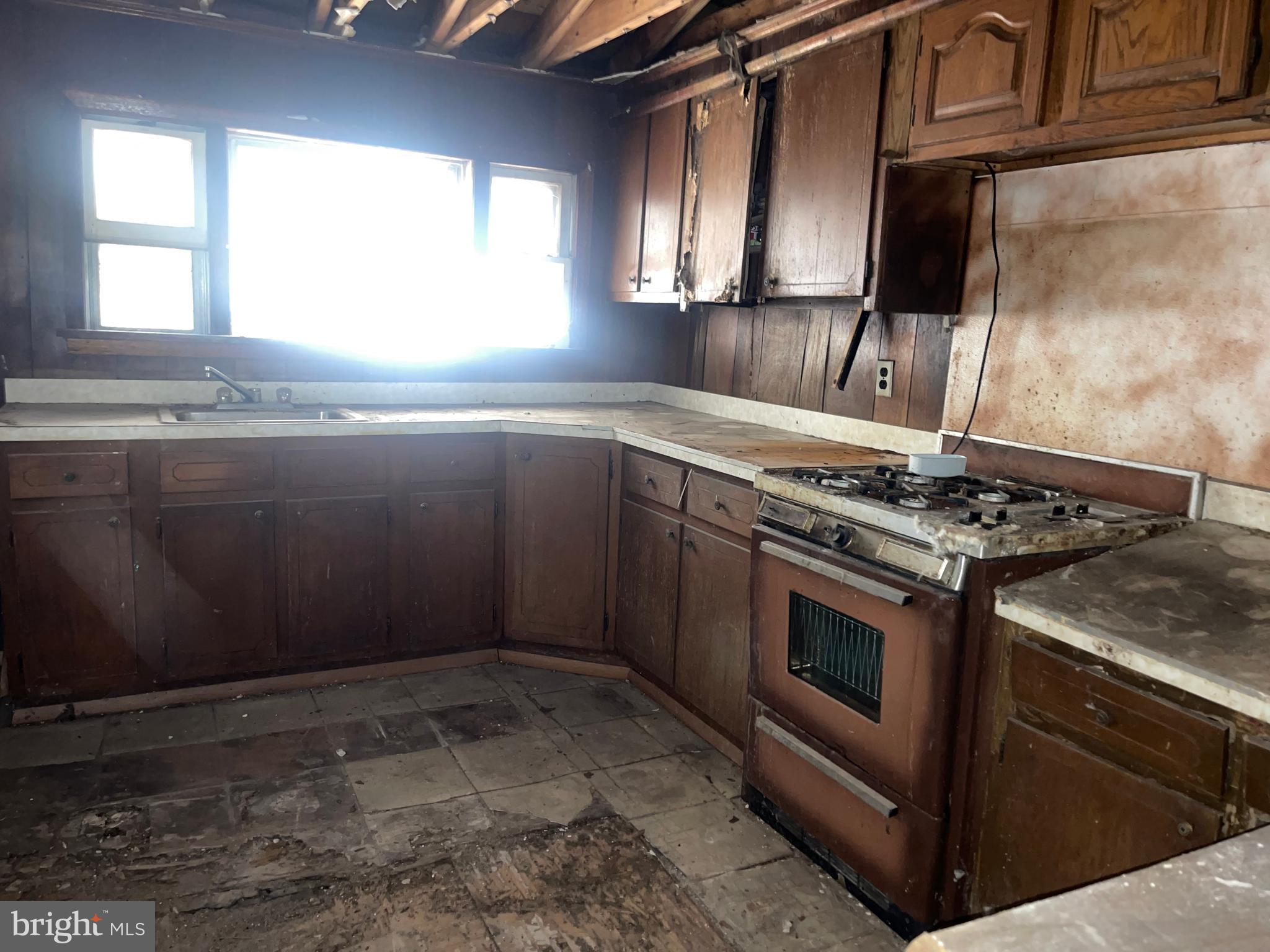 708 Jeffrey Street Chester, PA 19013 - Photo 7 of 13 a kitchen with granite countertop a stove and a sink