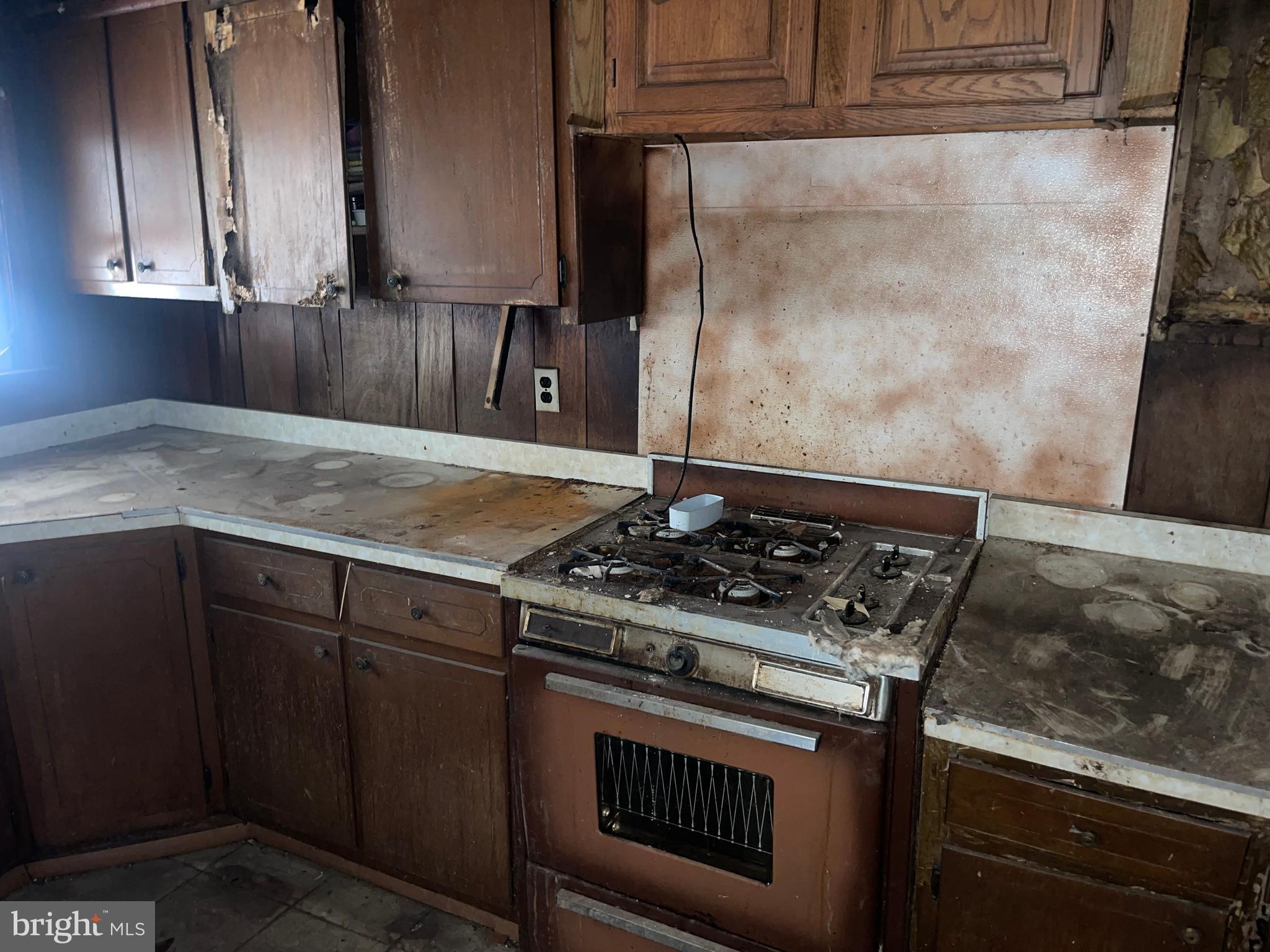 708 Jeffrey Street Chester, PA 19013 - Photo 8 of 13 a kitchen with granite countertop a stove and a sink