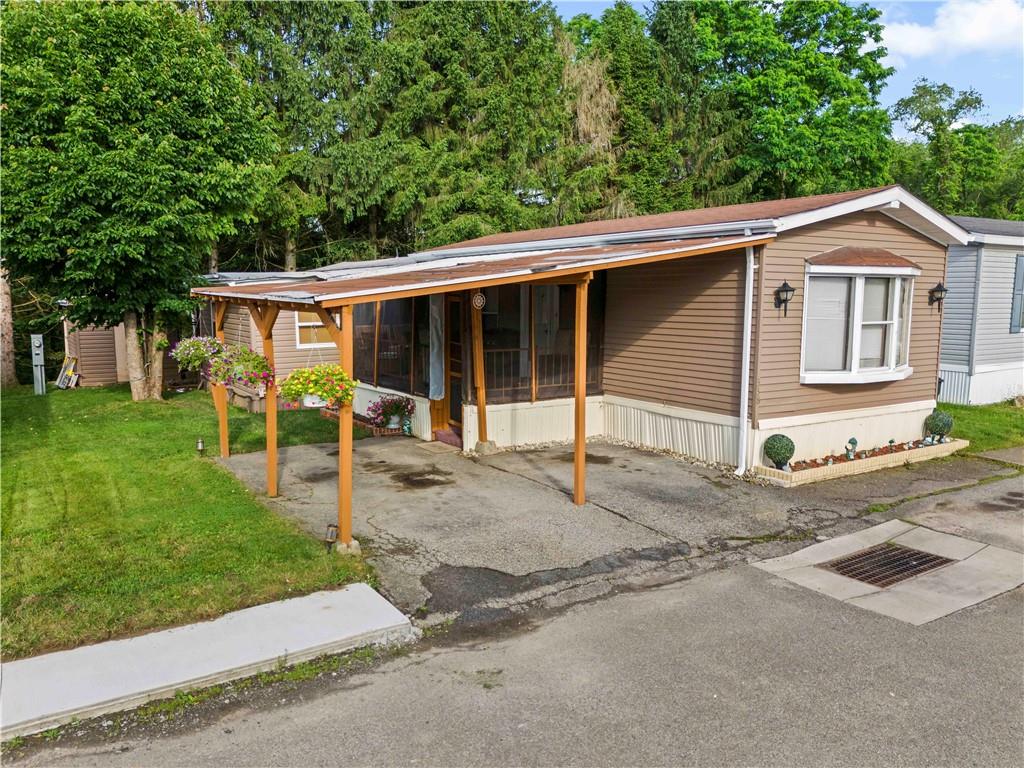 a view of a house with a yard and garden