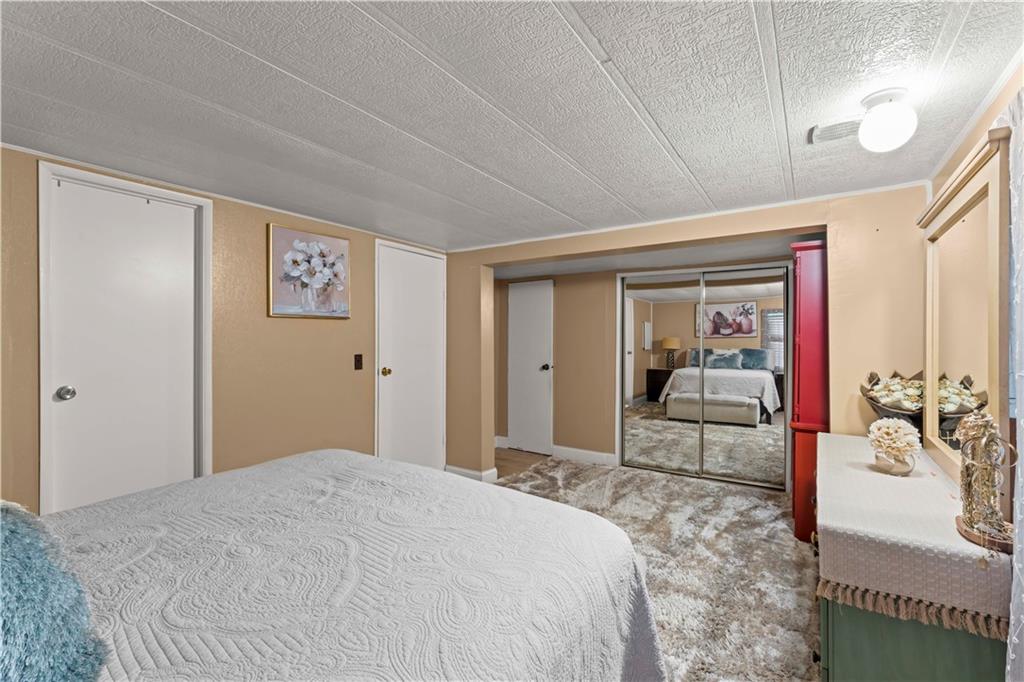 338 Festival Road Washington, PA 15301 - Photo 11 of 18 a bedroom with a bed and a mirror