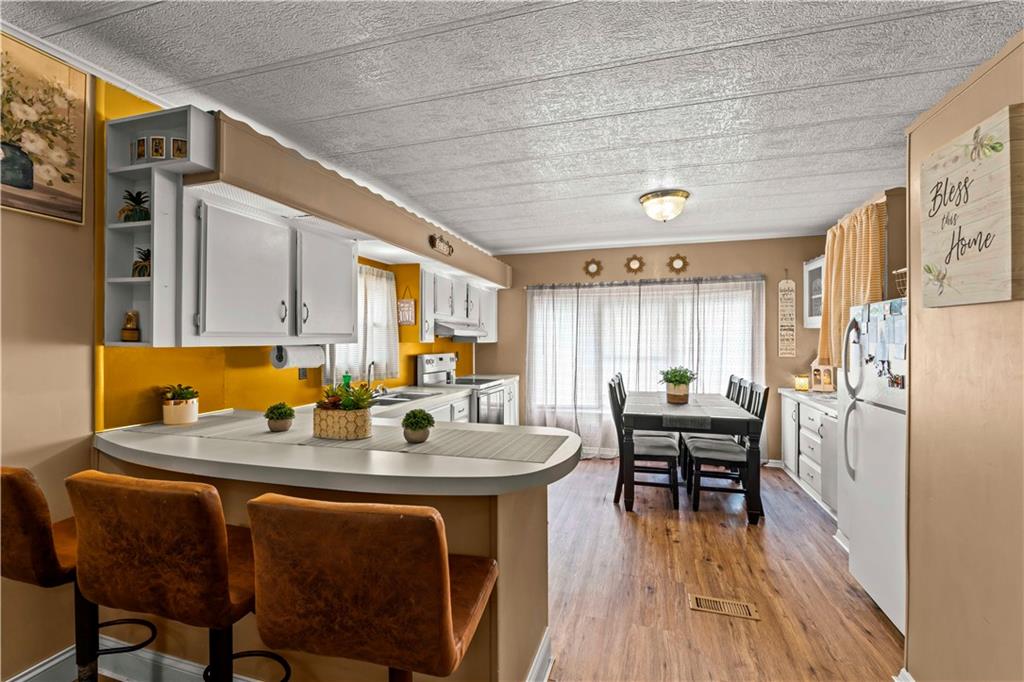 338 Festival Road Washington, PA 15301 - Photo 6 of 18 a kitchen with a dining table chairs and refrigerator