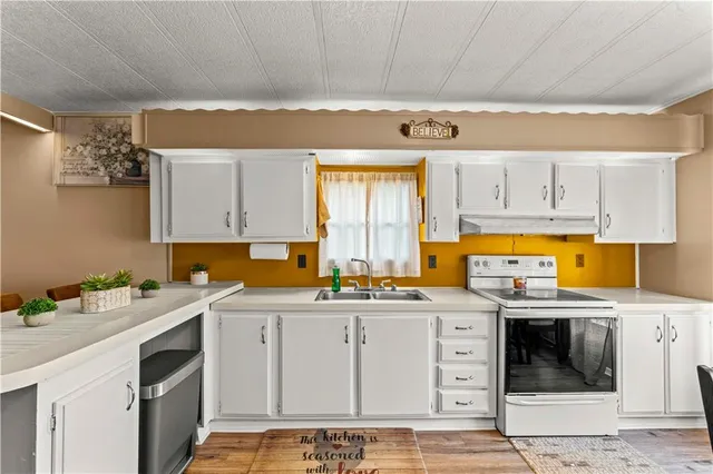 a kitchen with a sink stove and cabinets