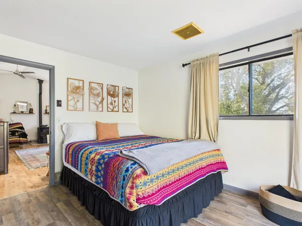 a bedroom with a large bed and a chandelier
