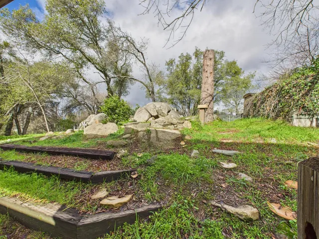 a spacious bedroom with a bed and a flat screen tv