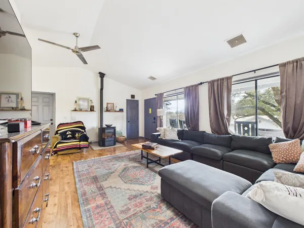 a living room with furniture and wooden floor