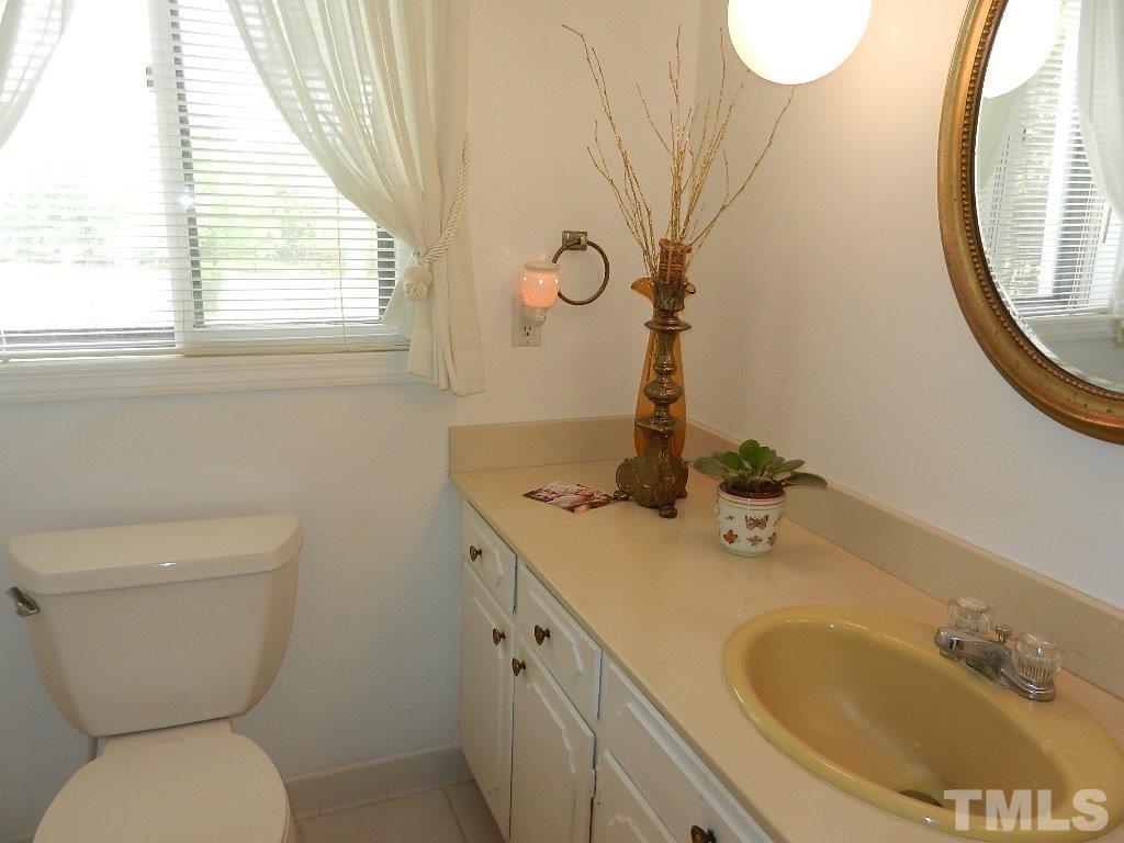 4424 Mitchell Mill Road Wake Forest, NC 27587 - Photo 14 of 25 a bathroom with a sink and a mirror
