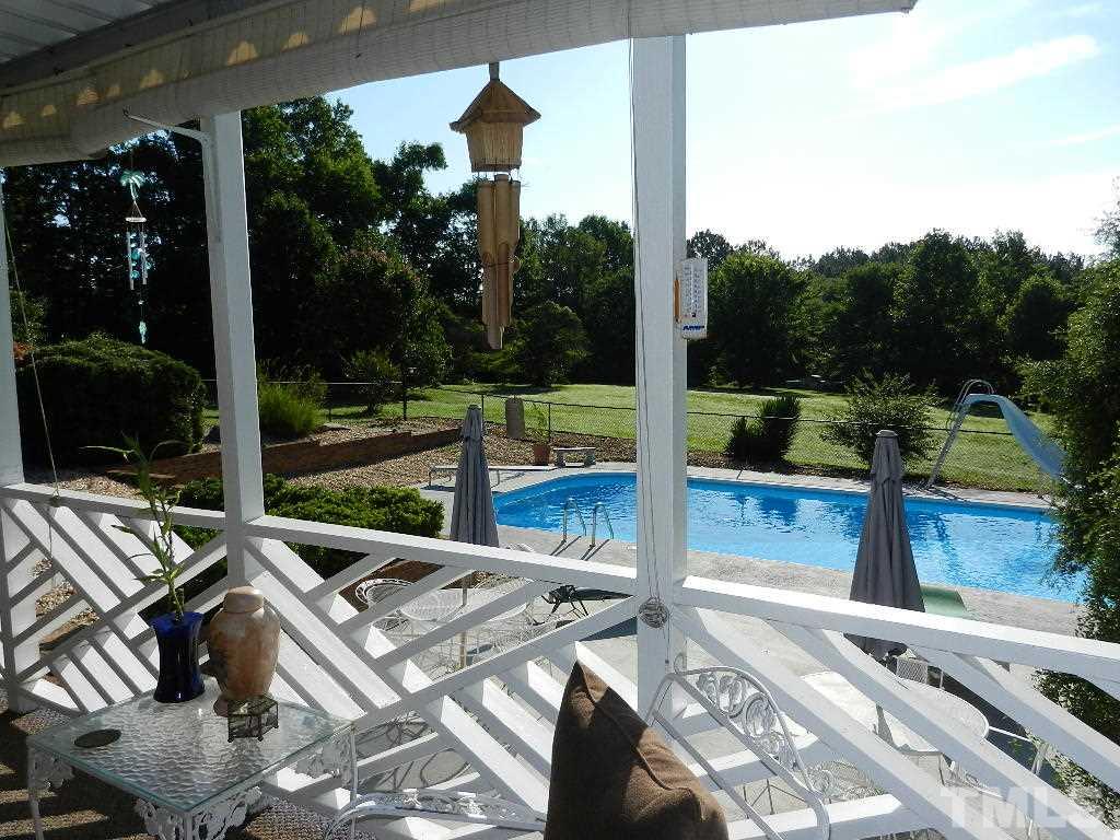 4424 Mitchell Mill Road Wake Forest, NC 27587 - Photo 21 of 25 a view of a patio with table and chairs and wooden floor