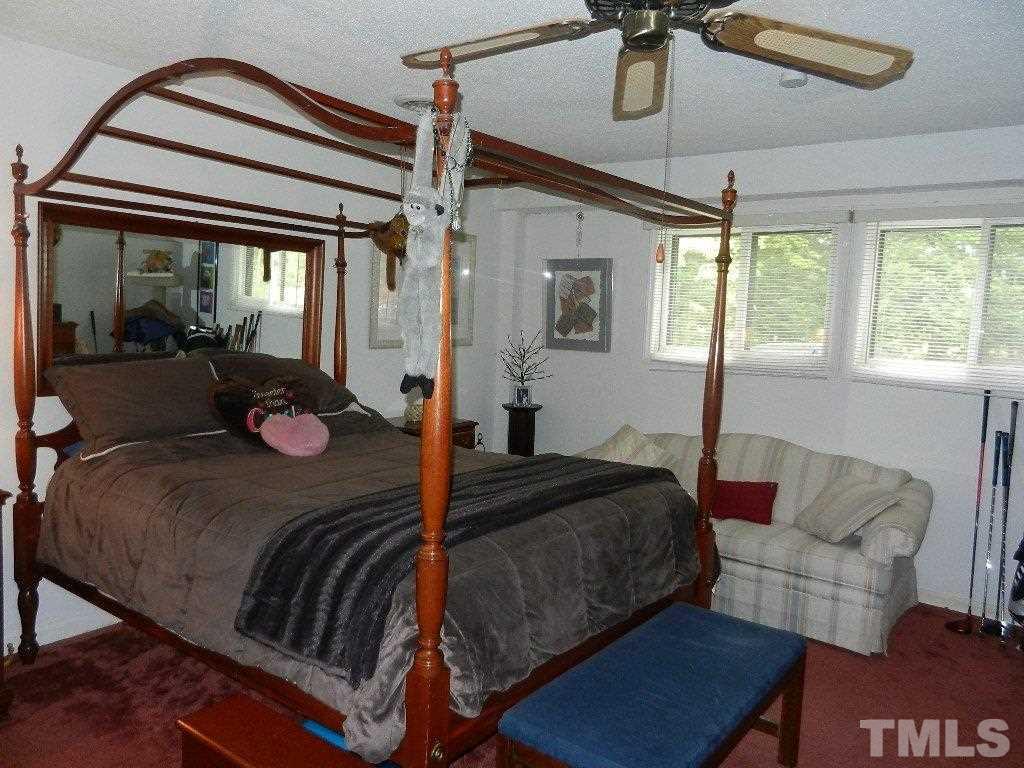 4424 Mitchell Mill Road Wake Forest, NC 27587 - Photo 22 of 25 a bedroom with a bed and wooden floor