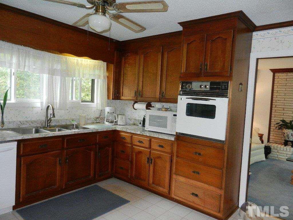 4424 Mitchell Mill Road Wake Forest, NC 27587 - Photo 10 of 25 a kitchen with a sink cabinets and window