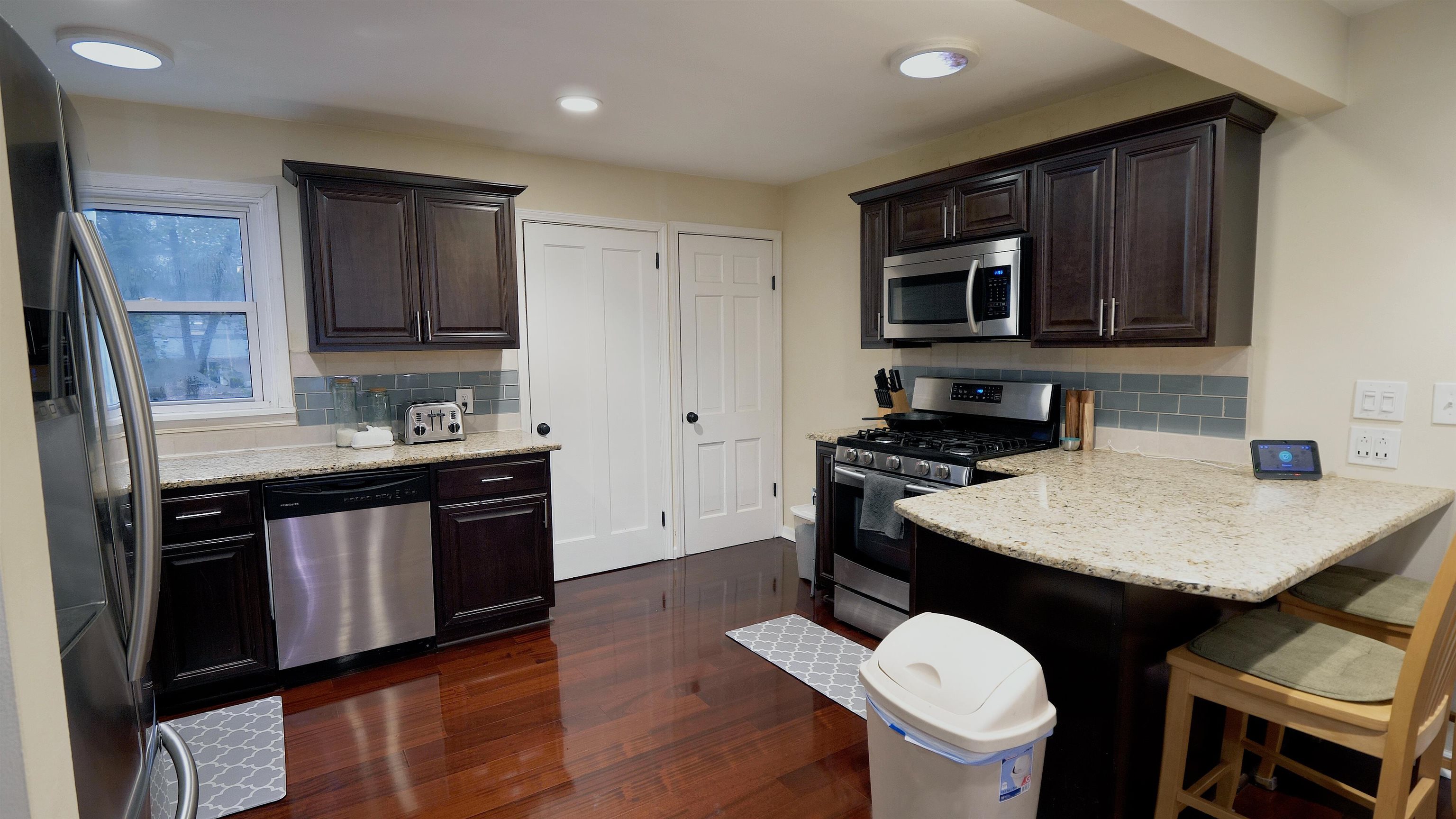 4626 Spring Creek Road Rockford, IL 61114 - Photo 7 of 31 a kitchen with a stove a sink and a microwave