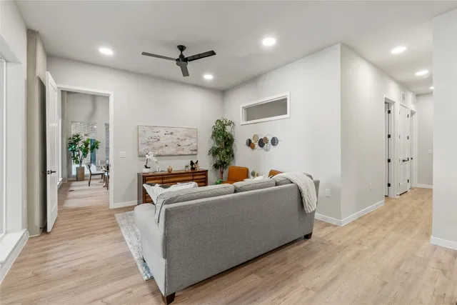 a living room with furniture and wooden floor