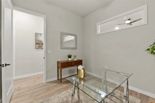 a view of a workspace room with wooden floor