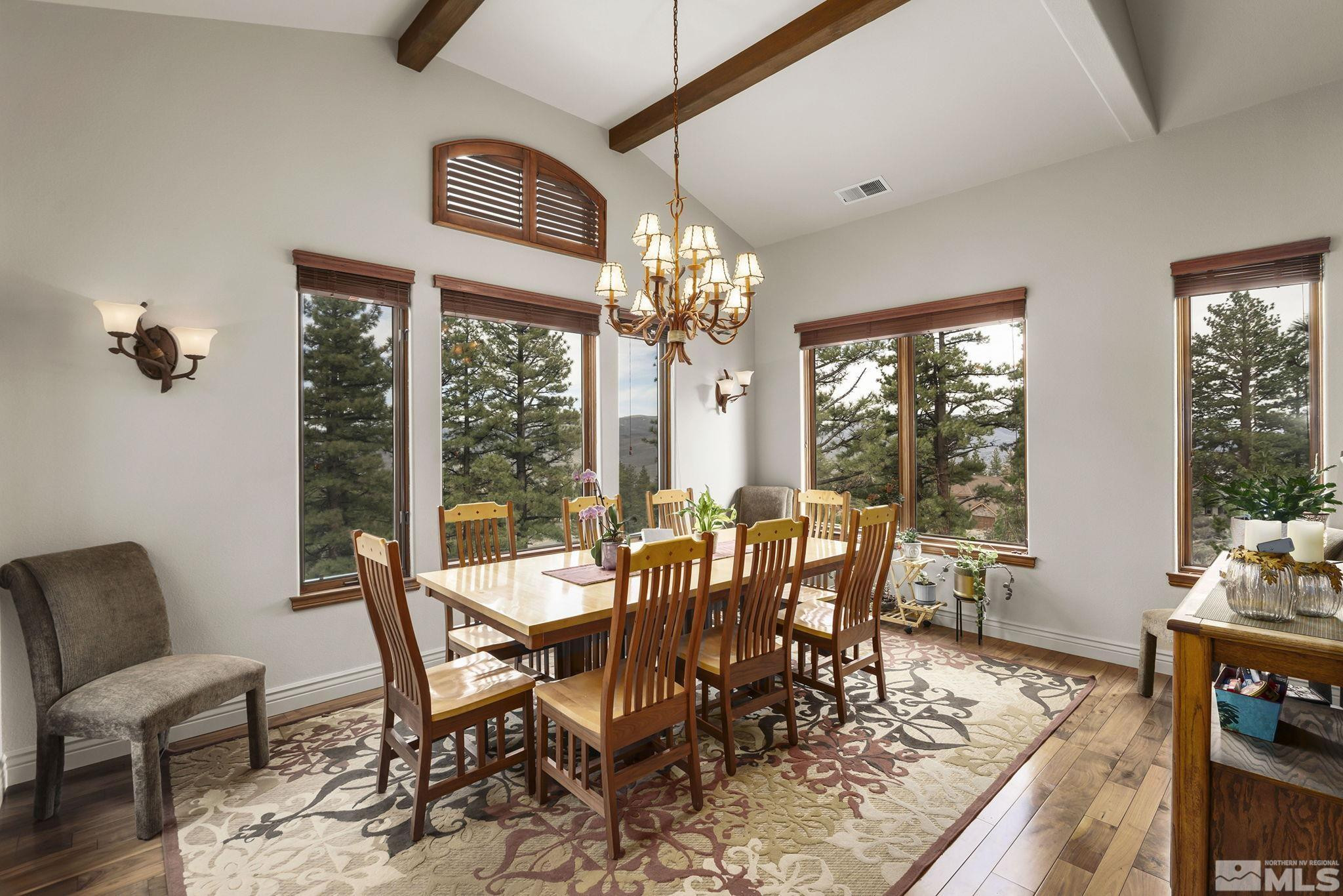 4660 West Pinewild Road Reno, NV 89511 - Photo 11 of 40 a view of a dining room with furniture a chandelier and wooden floor
