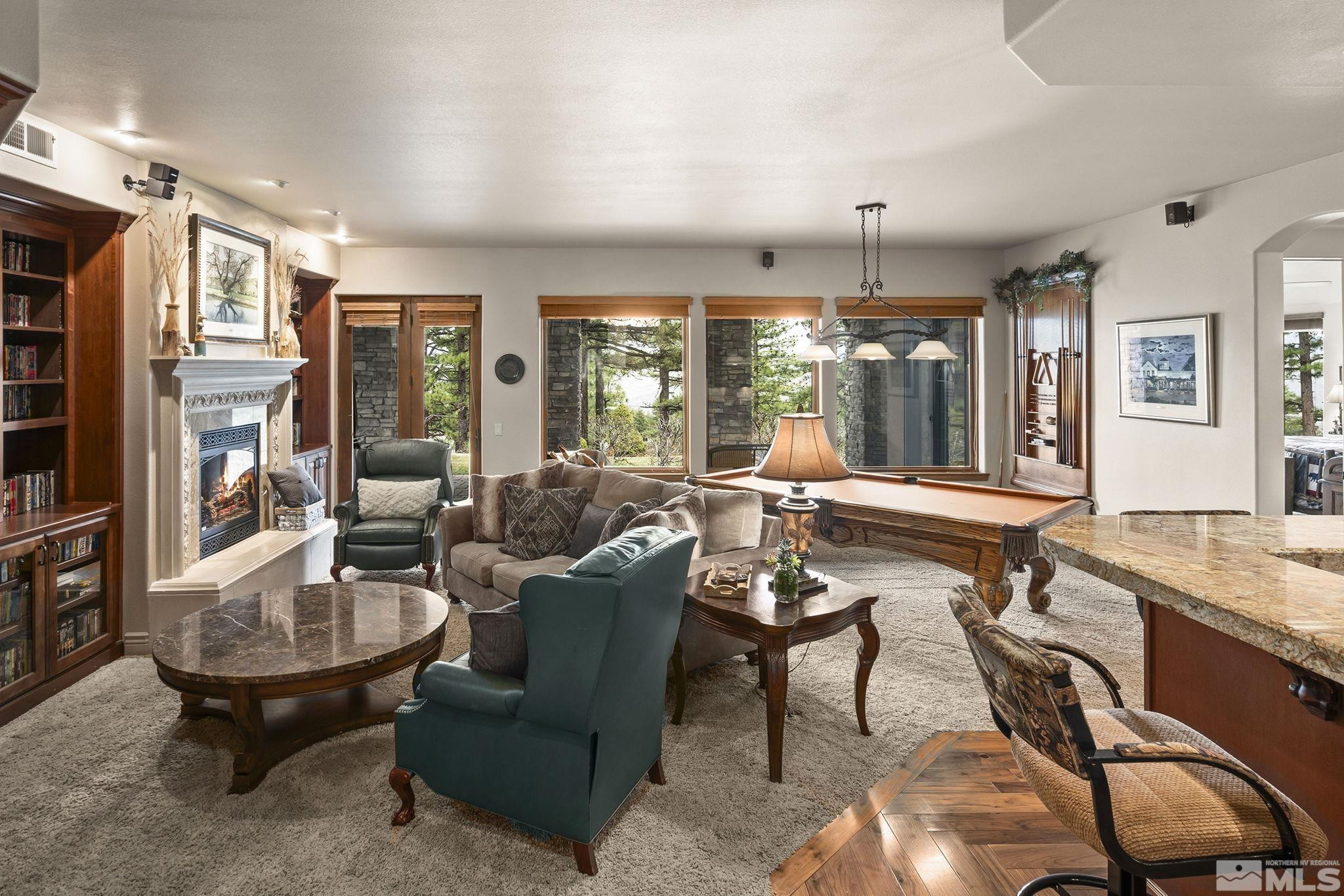 4660 West Pinewild Road Reno, NV 89511 - Photo 21 of 40 a living room with fireplace furniture and a large window