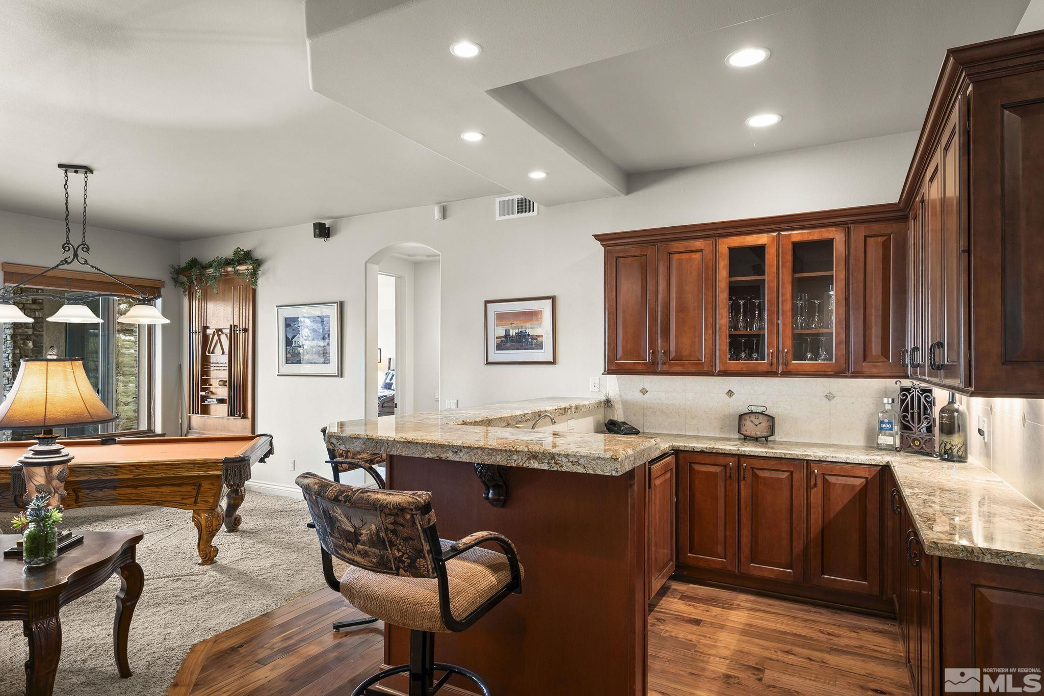 4660 West Pinewild Road Reno, NV 89511 - Photo 22 of 40 a kitchen that has a sink and a chair in it