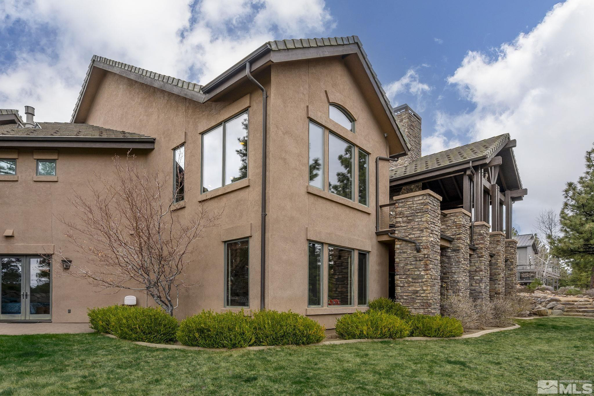 4660 West Pinewild Road Reno, NV 89511 - Photo 26 of 40 a view of a house with brick walls and a small yard