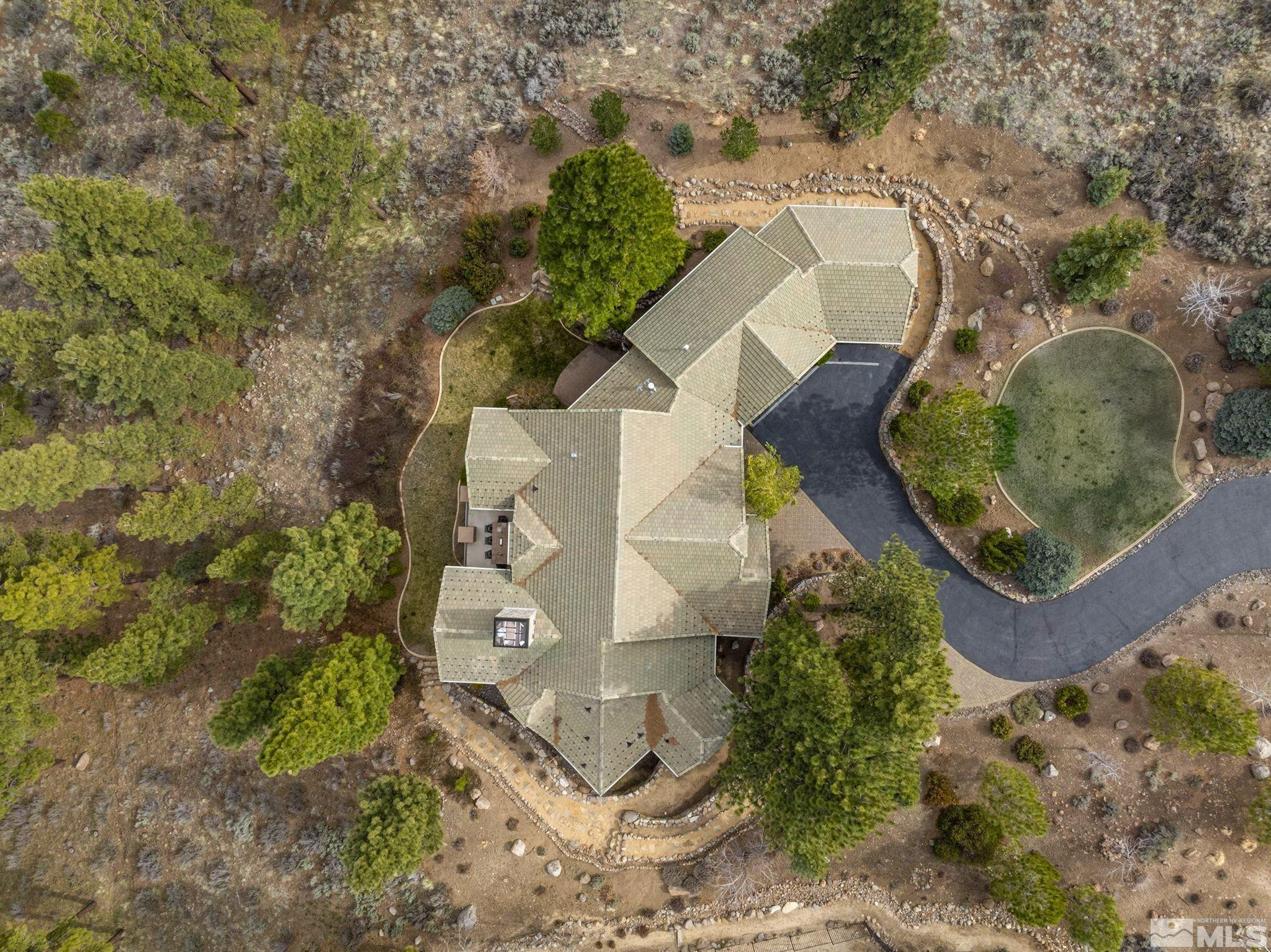 4660 West Pinewild Road Reno, NV 89511 - Photo 36 of 40 an aerial view of a house with a yard and trees