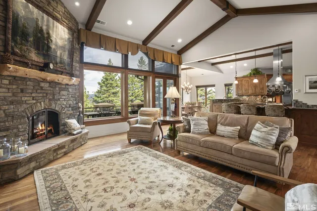 a living room with fireplace furniture and a floor to ceiling window