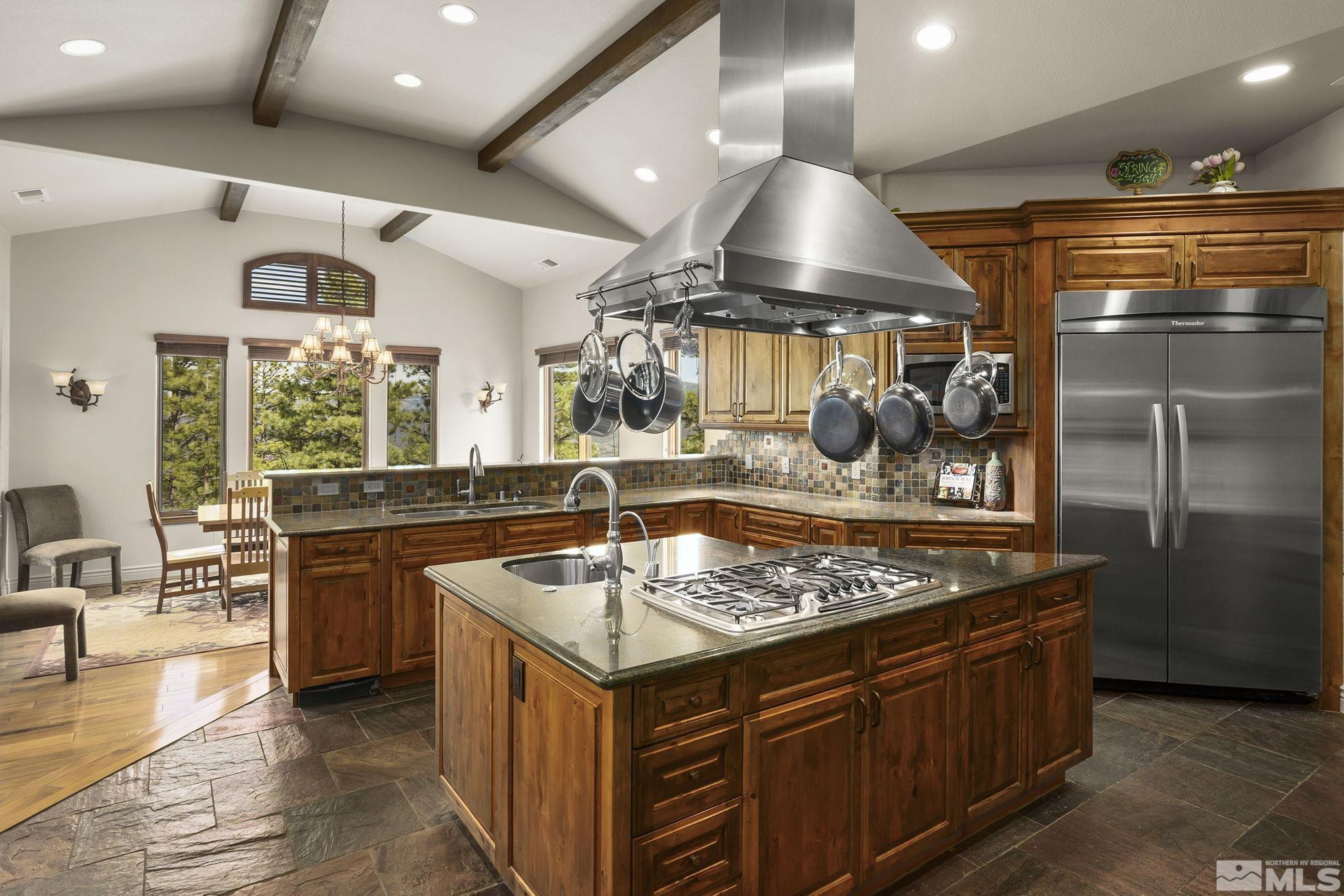 4660 West Pinewild Road Reno, NV 89511 - Photo 10 of 40 a kitchen with stainless steel appliances granite countertop a stove and a sink