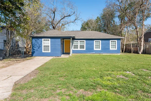 a brick house that is sitting in front of a house