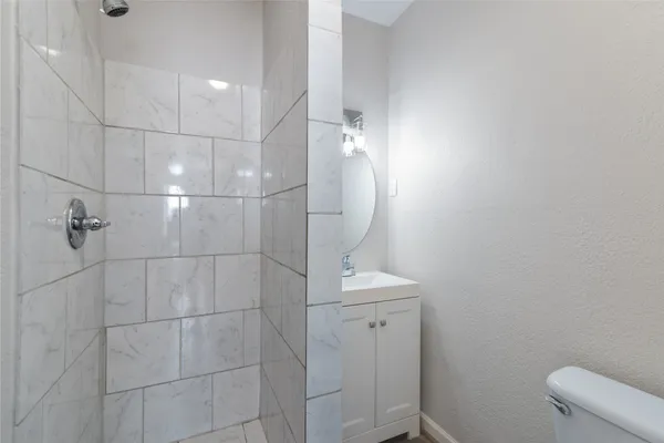 a bathroom with a toilet and shower