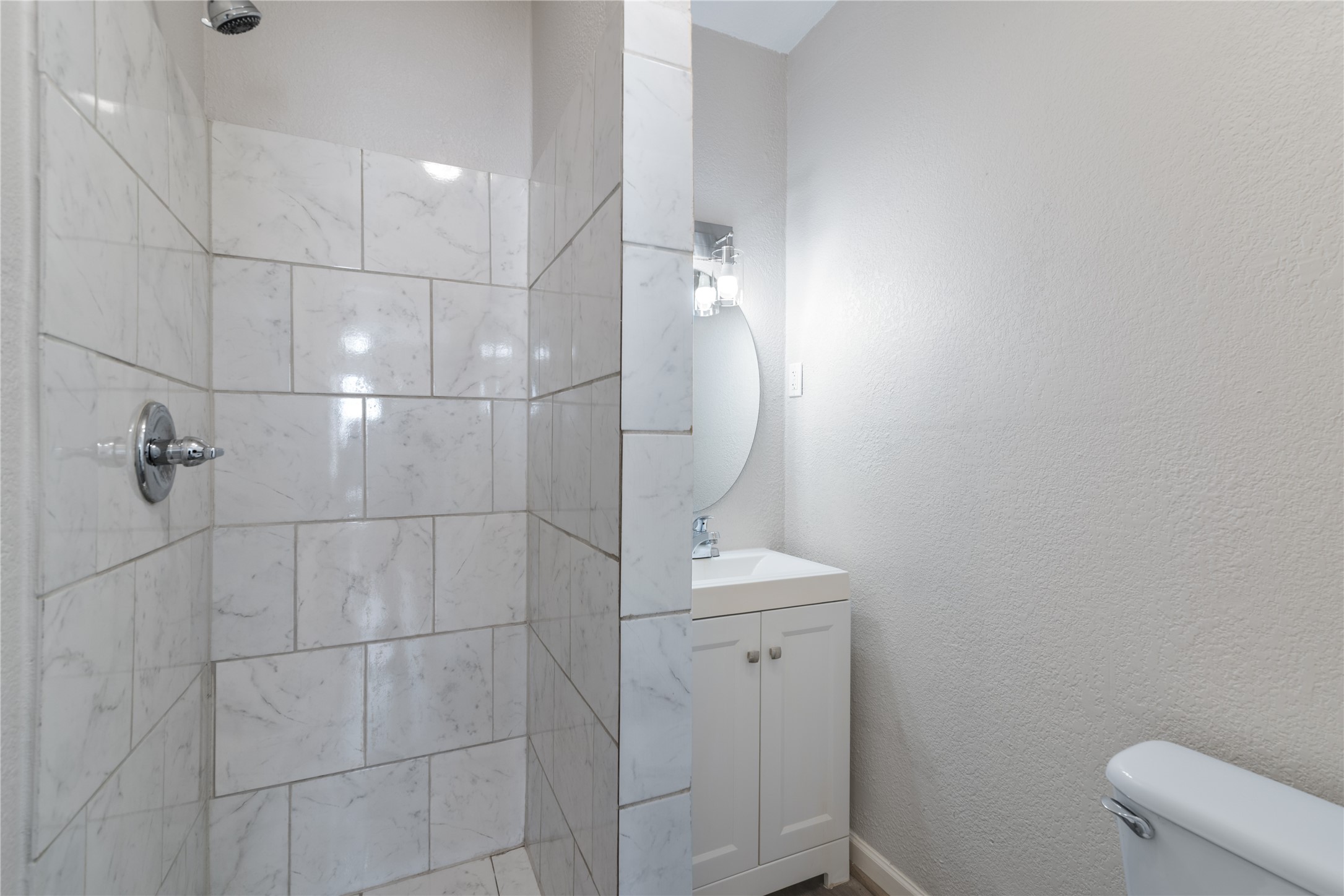 5825 Southurst Street Houston, TX 77033 - Photo 13 of 23 a bathroom with a toilet and shower
