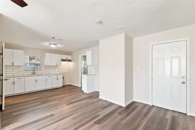 a view of a kitchen with wooden floor