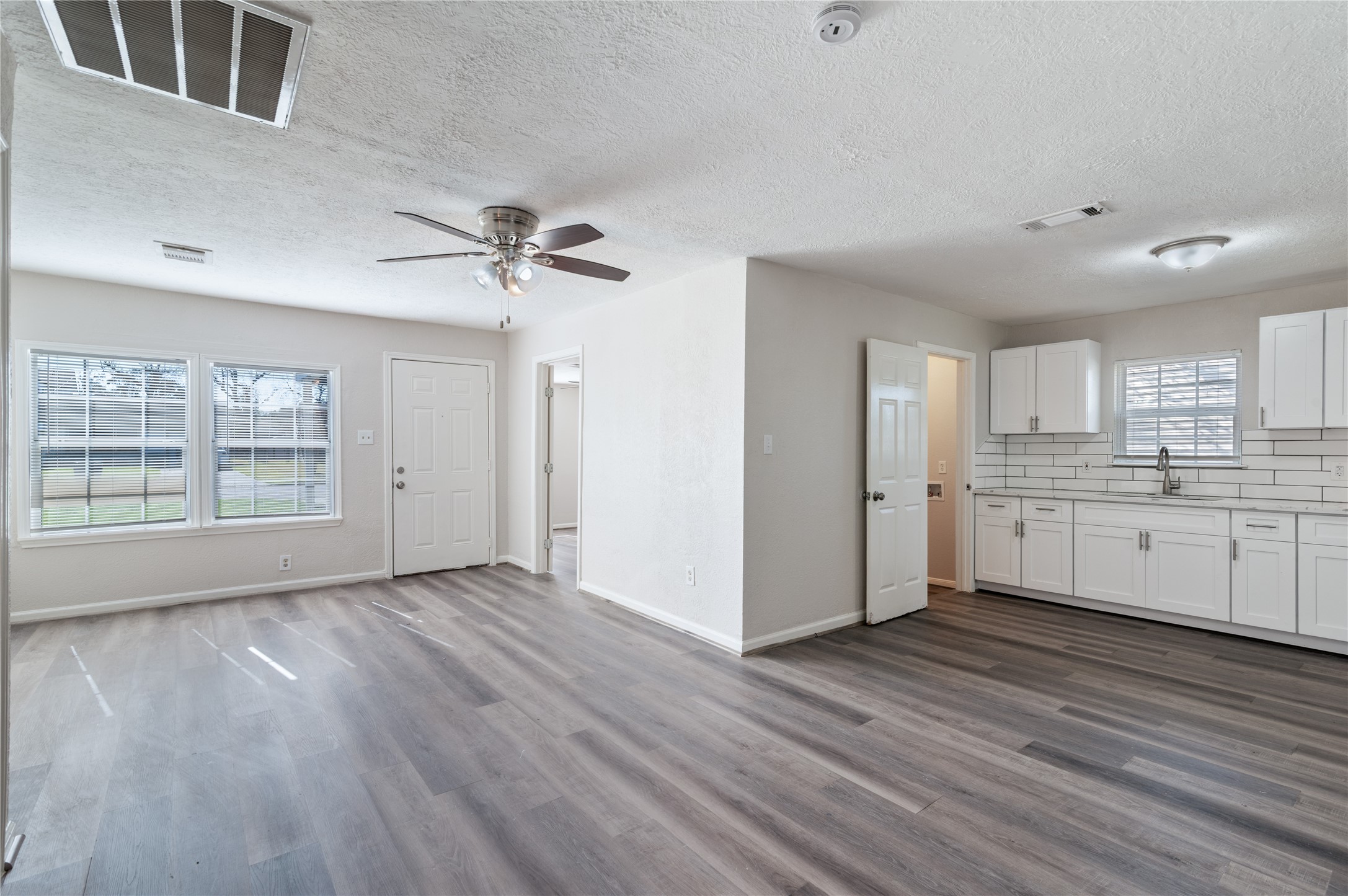 5825 Southurst Street Houston, TX 77033 - Photo 5 of 23 a view of an empty room with a kitchen and a window