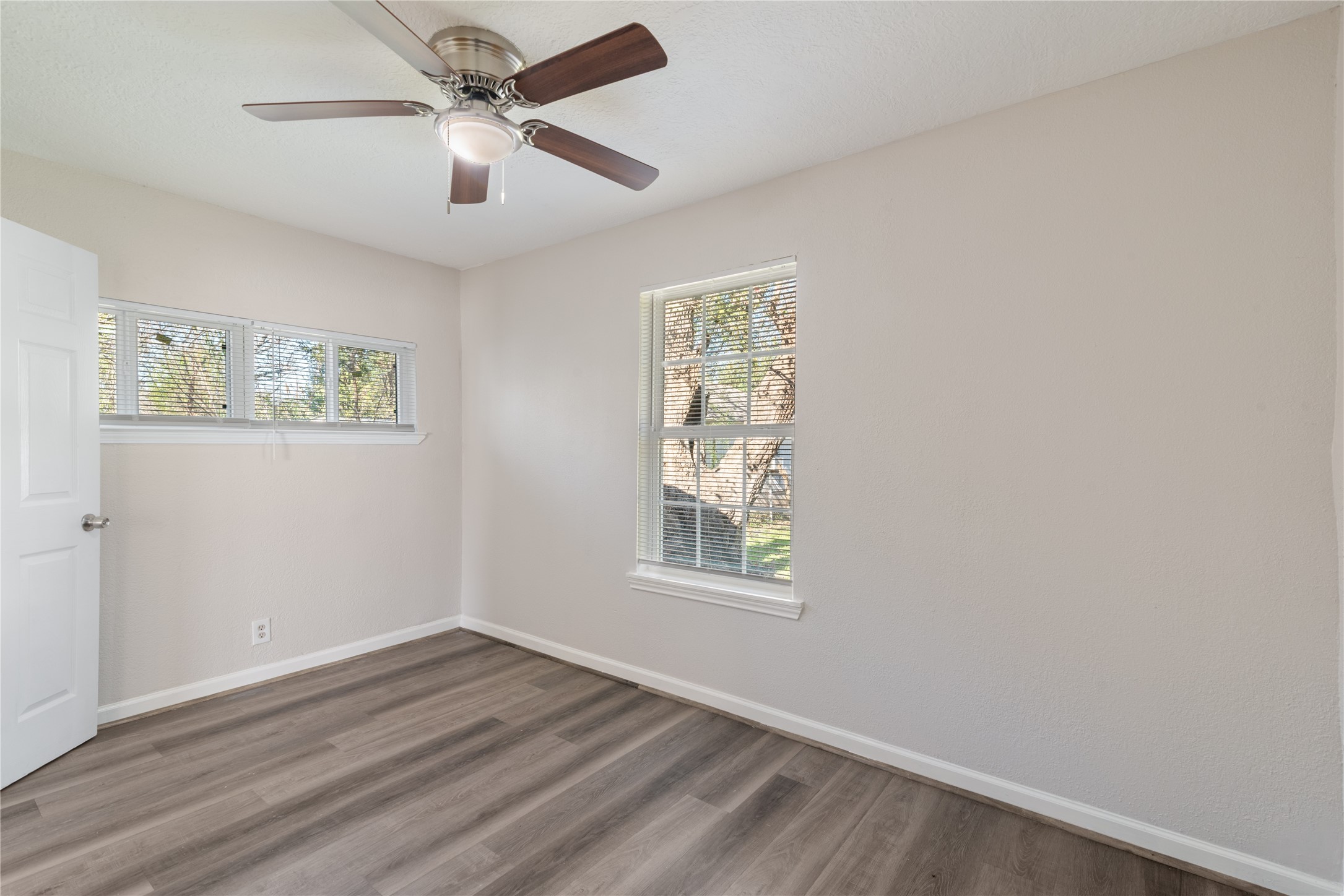 5825 Southurst Street Houston, TX 77033 - Photo 10 of 23 a view of an empty room with a window and wooden floor