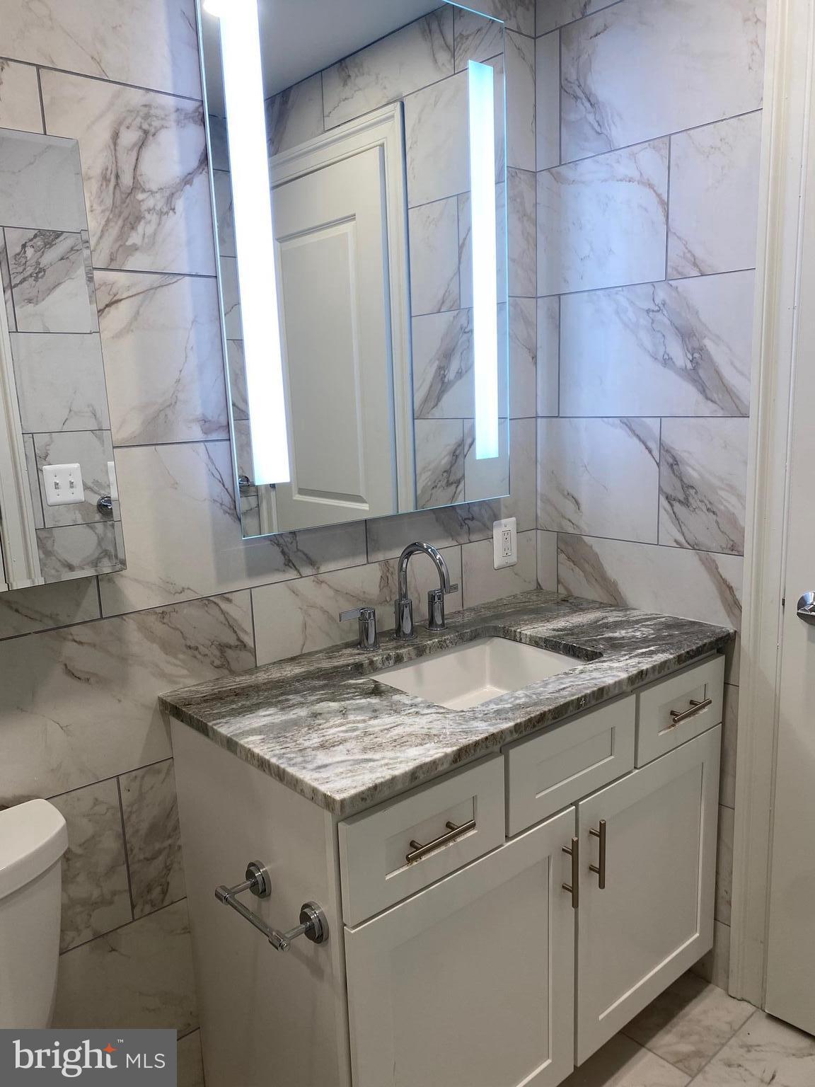 1900-20 Arch Street, Unit 109 Philadelphia, PA 19103 - Photo 13 of 34 a bathroom with a sink and vanity