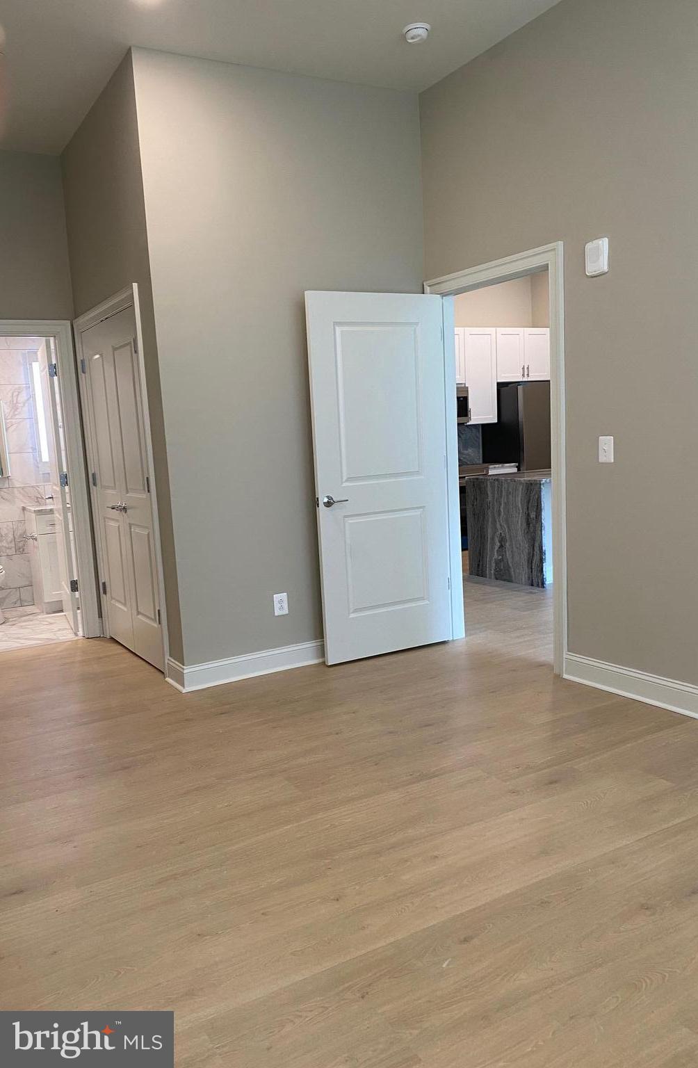 1900-20 Arch Street, Unit 109 Philadelphia, PA 19103 - Photo 6 of 34 a view of livingroom with a flat screen tv with kitchen view