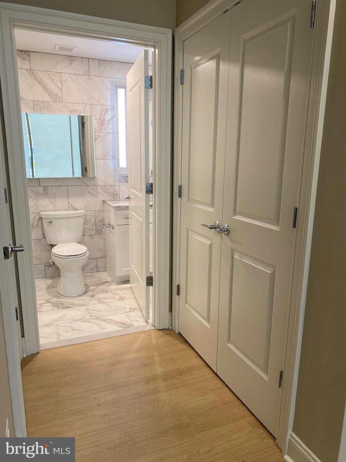 1900-20 Arch Street, Unit 109 Philadelphia, PA 19103 - Photo 8 of 34 a bathroom with a sink and a mirror