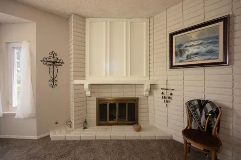 a view of a livingroom with furniture and a fireplace