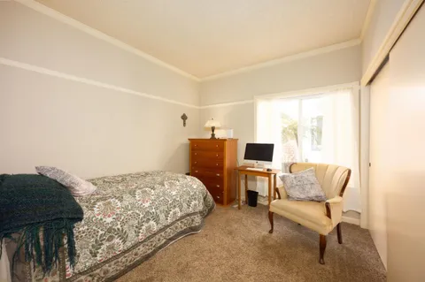 a bedroom with a bed and chair