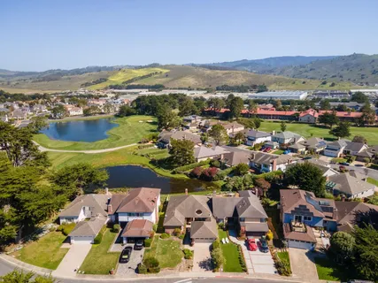 an aerial view of residential houses with outdoor space