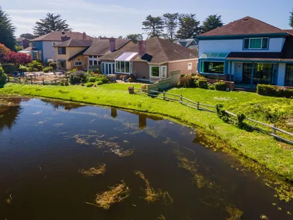 a front view of a house with a yard table and chairs