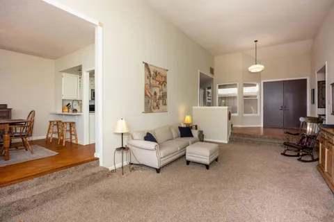 a living room with furniture and a chandelier