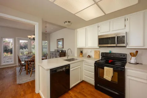 a kitchen with a sink stove and microwave