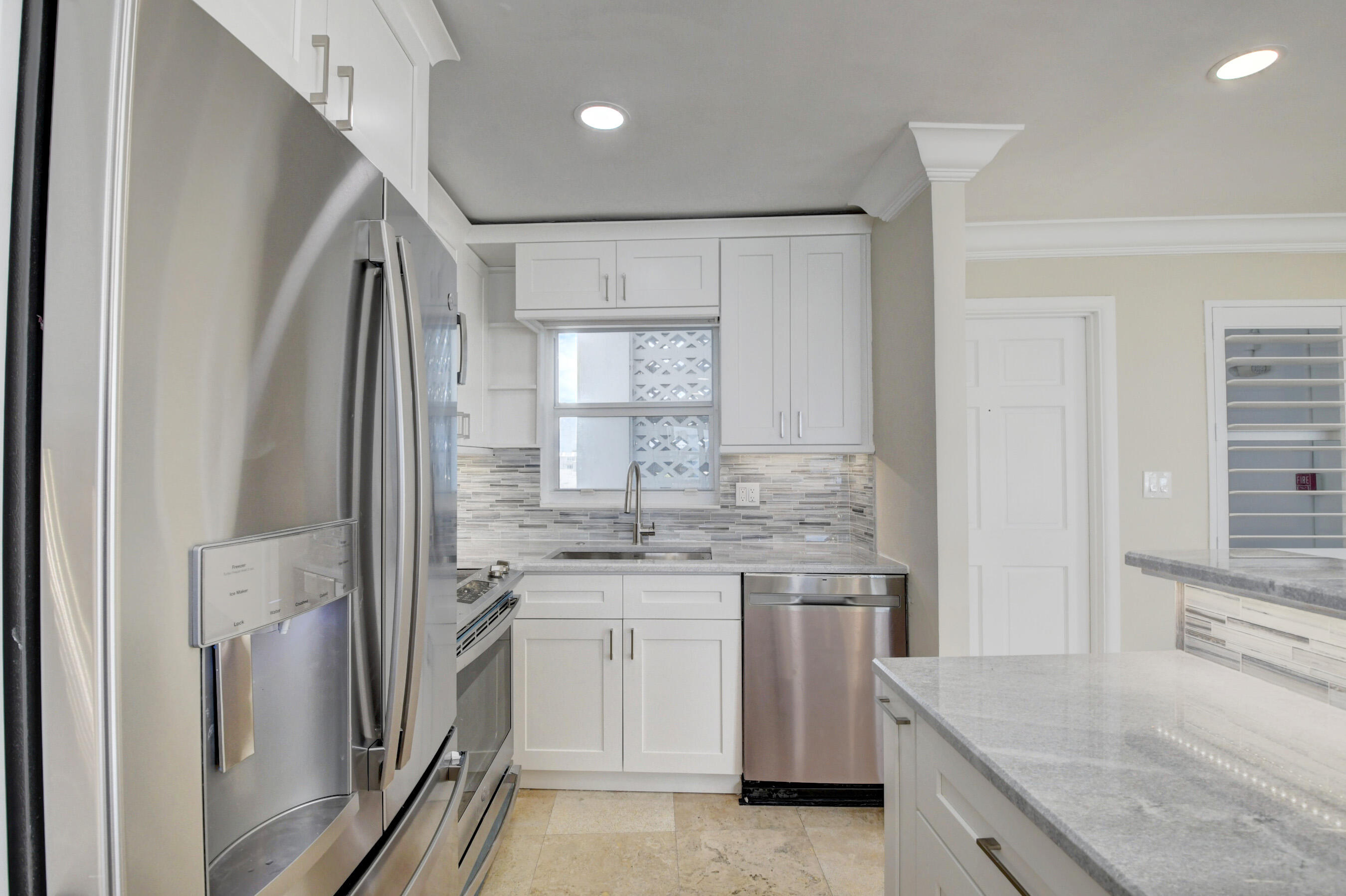 36 South Ocean Boulevard, Unit B3 Delray Beach, FL 33483 - Photo 18 of 47 a kitchen with a sink stove and refrigerator
